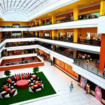 **Prompt for The Palms Shopping Mall:**
    "A bustling, modern shopping mall interior in Lagos, Nigeria, showcasing diverse international and local retail stores, a vibrant food court with various cuisines, a lively cinema entrance, and a dedicated children's play area. Emphasize a clean, spacious, and air-conditioned environment with natural light."